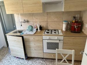 uma pequena cozinha com um fogão e um lavatório em Villa Model em Buonabitacolo