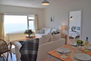 a living room with a couch and a table at Westcroft 6 Withnoe Terrace in Torpoint