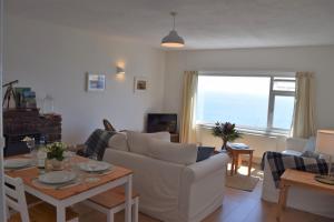 a living room with a couch and a table at Westcroft 6 Withnoe Terrace in Torpoint