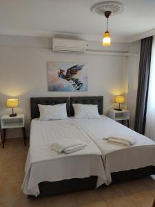 a bedroom with a large bed with two towels on it at FA&BER Homes in Marmaris +84 photos