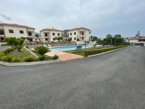 an empty street with houses and a swimming pool at Ohana Holiday in San Nicola Arcella