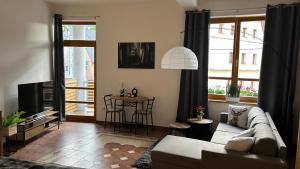 a living room with a couch and a table at Apartmán Smrk in Vrbno pod Pradědem