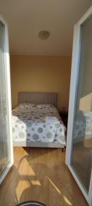 a bedroom with a bed with polka dot sheets at Apartments Burazer in Šibenik