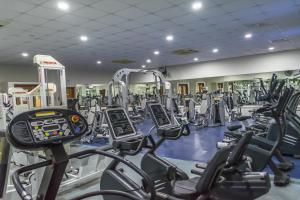 a gym with rows of treadmills and machines at Aktea Beach Village in Ayia Napa