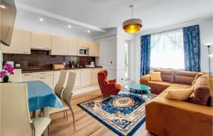 a kitchen and living room with a couch and a table at 1 Bedroom Cozy Apartment In Kolobrzeg in Kołobrzeg
