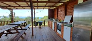 a kitchen with a wooden deck with a table and a stove at LJUBAC GLAMPING BELL TENT Robinson in Ljubač