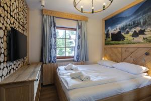 sypialnia z dużym łóżkiem i dużym oknem w obiekcie Górskie Szczyty Apart & SPA Apartament 11 Sauna Jacuzzi i Parking w cenie w Zakopanem