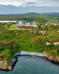 an aerial view of a house on a hill next to the water at Seabrook Lodge Clifden Connemara in Clifden