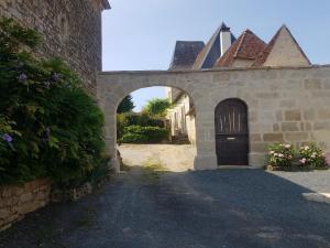 an entrance to a stone building with a door at La Maison Haute in Nailhac