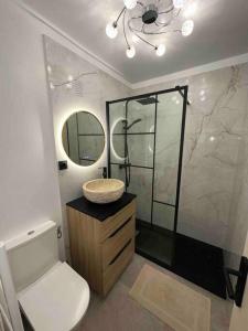 a bathroom with a sink and a toilet and a mirror at Appartement au centre de Saint-tropez avec terrasse in Saint-Tropez