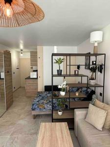 a living room with a bed and a couch at Appartement au centre de Saint-tropez avec terrasse in Saint-Tropez