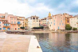 un grupo de edificios junto a una masa de agua en Studio avec terrasse au centre de Saint-Tropez, en Saint-Tropez