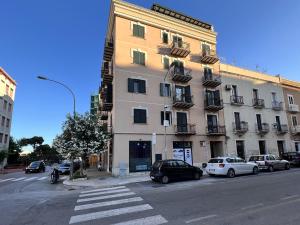 a large building with cars parked in front of it at Osorio 74 Apartments in Trapani