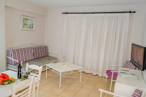 a living room with a couch and a table at Aktea Beach Village in Ayia Napa