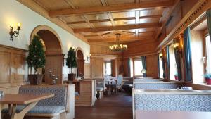 a restaurant with tables and chairs and a dining room at Hotel Edelweiẞ garni in Berwang