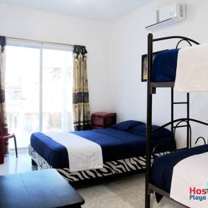 Ένα ή περισσότερα κρεβάτια σε δωμάτιο στο Hostal Playa Imperial Manta