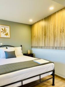 a bedroom with a bed and a wooden wall at Iris Luxury House in Áyioi Dhéka