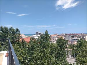 a view of a city from a balcony with trees at bellavista civico 100 in Pescara