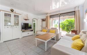 a living room with a couch and a table at Lovely Home In Vias With Outdoor Swimming Pool in Vias