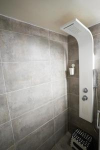 a bathroom with a shower with a shower head at Angel Apartment in Athens