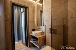 a bathroom with a sink and a mirror at Veranda in Slavske