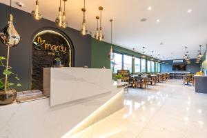 a restaurant with a white counter and tables and chairs at Mardy Suit Hotel in Istanbul
