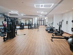 a gym with treadmills ellipticals and exercise bikes at Beautiful 1 Bedroom at Soho Square at Al Saadiyat Island in Abu Dhabi