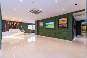 a lobby with green walls and a white tile floor at Mardy Suit Hotel in Istanbul