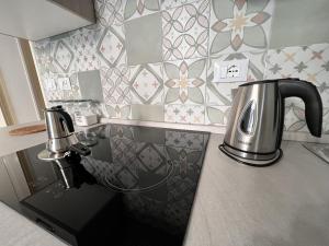 a kitchen counter with a tea kettle on it at Osorio 74 Apartments in Trapani