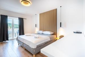 1 dormitorio con cama y ventana grande en Apartments & Rooms Klemenc en Cres