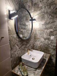 a bathroom with a sink and a mirror on a wall at Pine & sea house in Nikiti