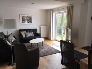a living room with a couch and a table at Föhrrückt in Wyk auf Föhr