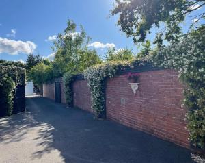 a brick wall with a flower pot on it at The Sanctuary in Exmouth