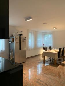 a kitchen with a table and a refrigerator in a room at Mosaikhaus Smart Home in Würselen