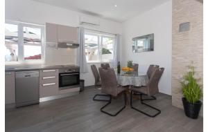 a kitchen and dining room with a table and chairs at Three-Bedroom Holiday Home In Suhi Potok in Jesenice
