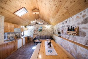 a kitchen and living room with a wooden ceiling at Holiday house Manuela in Kruševo