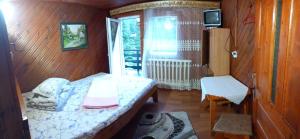 a small bedroom with a bed and a window at PERLA CĂLIMANILOR in Vatra Dornei