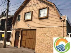 a house with a solar panel on it at Departamentos comodos y hermosos full equipados con baño y cocina privados in Santiago