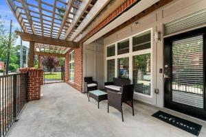 a patio with chairs and a table on a porch at East Atlanta Retreat Haven of Fun and Comfort! in Atlanta