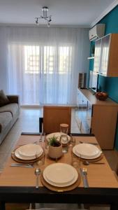 a living room with a table with plates on it at Apartamento Torremar M in El Borseral