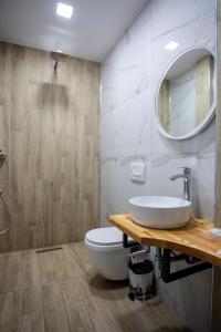 a bathroom with a sink and a toilet at Nuevo Deluxe in Shëngjin