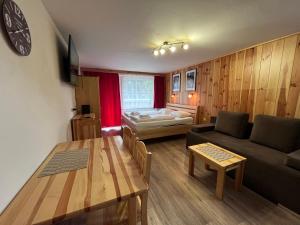 a living room with a couch and a table at Kaprun Mountain Studio with Summer CARD- Central Location in Kaprun