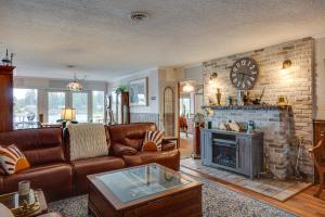 a living room with a couch and a fireplace at Tacoma Home on Steilacoom Lake with Dock! in Tacoma