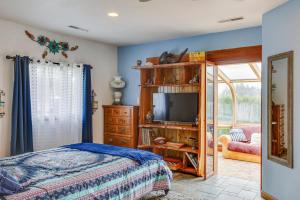 a bedroom with a bed and a television at Tacoma Home on Steilacoom Lake with Dock! in Tacoma