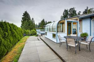 a tiny house with a table and chairs on a patio at Tacoma Home on Steilacoom Lake with Dock! in Tacoma