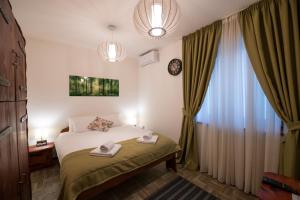 a hotel room with a bed and a window at Gardoš rooms in Zemun