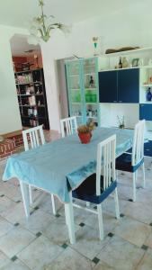 a dining room table with chairs and a blue table cloth at Casa Luciano 