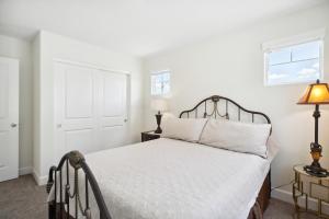 a white bedroom with a bed and a window at Carson City Retreat about 1 Mi to Hot Springs! in Carson City