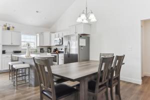a kitchen with a wooden table and chairs at Charming St Robert Home Near Downtown Waynesville! in Waynesville