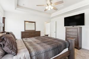 a bedroom with a bed and a flat screen tv at Charming St Robert Home Near Downtown Waynesville! in Waynesville